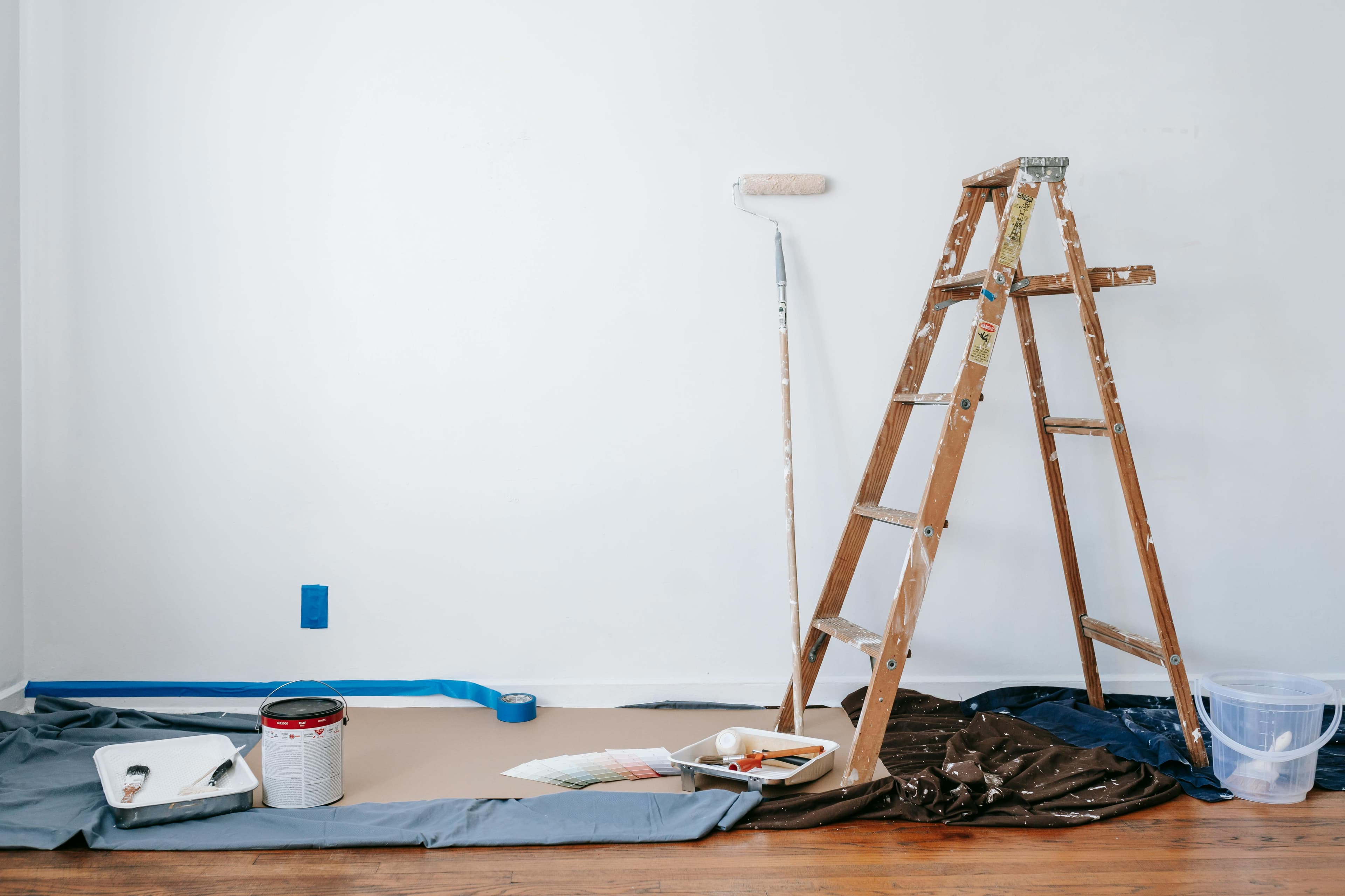 Painting supplies and ladder, in room ready to be painted